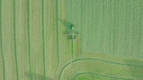 Aerial-Tracking-Shot-of-A-Farmer-Cutting-Silage-On-A-Warm-Summer-Day,-Scotland
