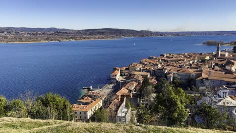 Panoramic-wide-angle-view-from-Rocca-Borromeo-viewpoint-of-Arona-cityscape-and-Maggiore-lake-in-Piedmont,-Italy