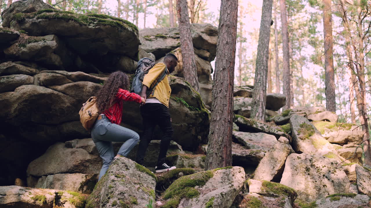 Couple Hiking Through Rocky Forest Path
