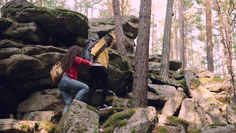 couple hiking through rocky forest path