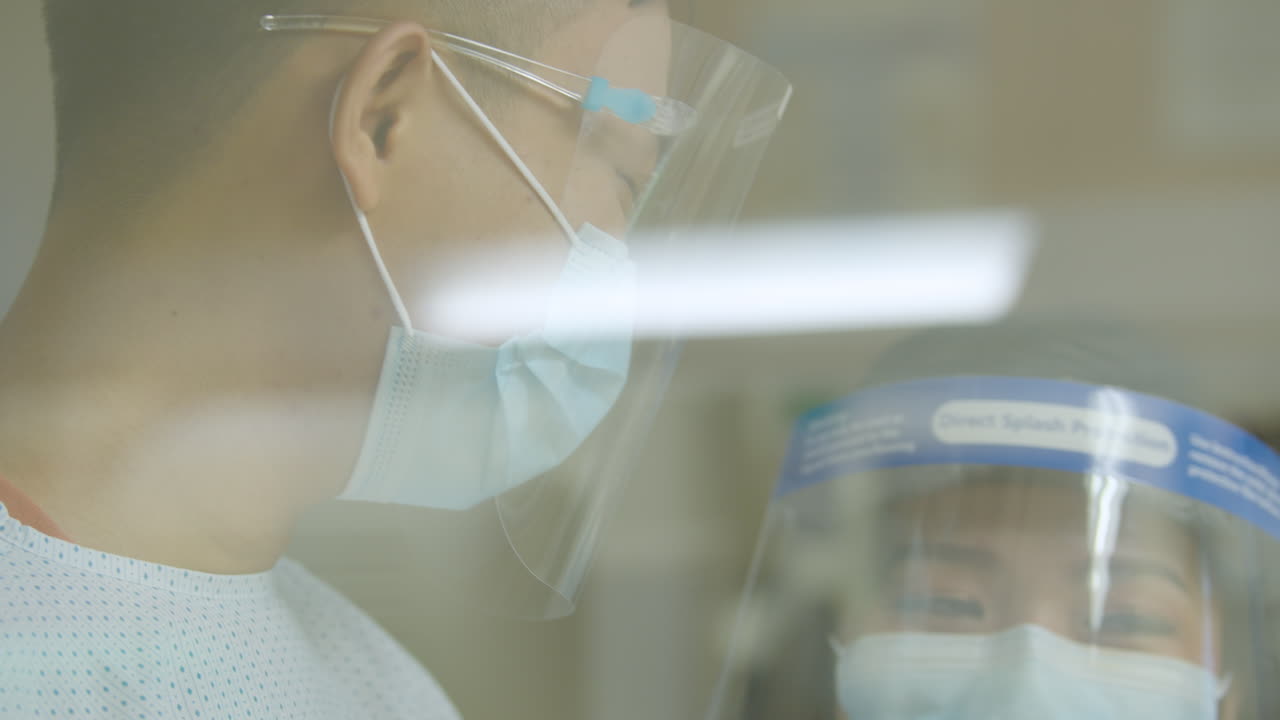 Close Up Of Parents Wearing Face Mask, Looking At New Born Child
