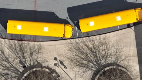 shadows of school bus line up as students leave school and get transported