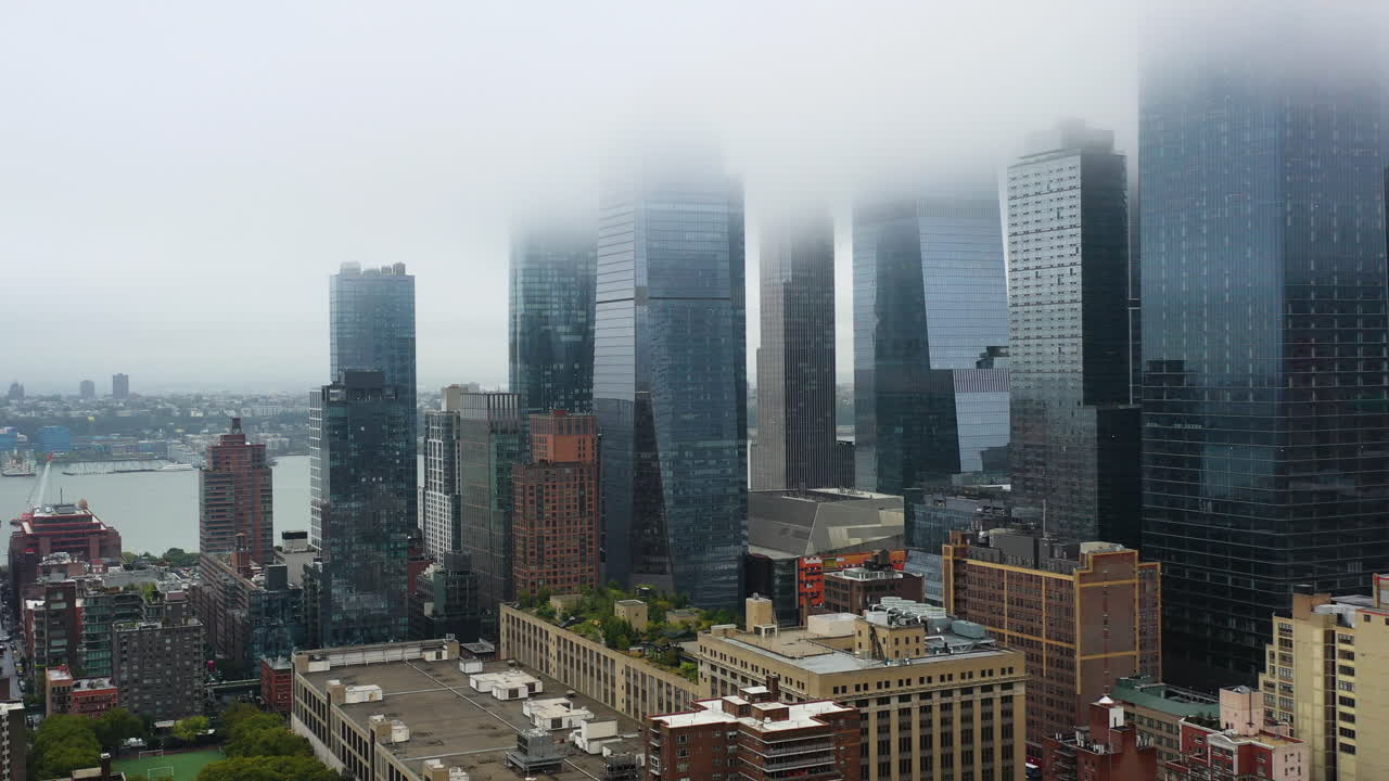Aerial view rising toward the skyscrapers in Hudson Yards, foggy day in New York