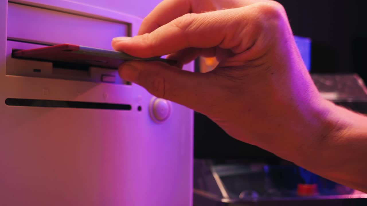 Using diskette for old computer. Music recorder, playing retro computer games. Vintage device for office, obsolete technology. . High quality 4k footage