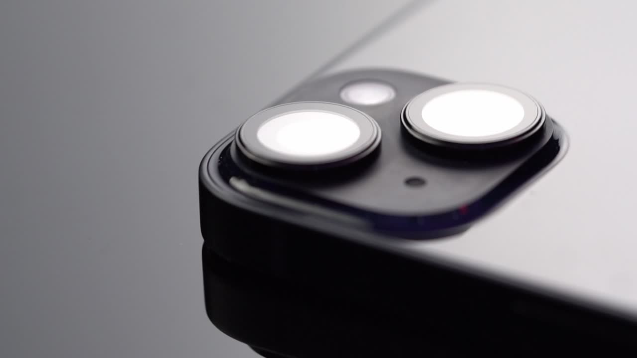 Macro close up of smartphone dual camera lens with reflective surface, studio product shot