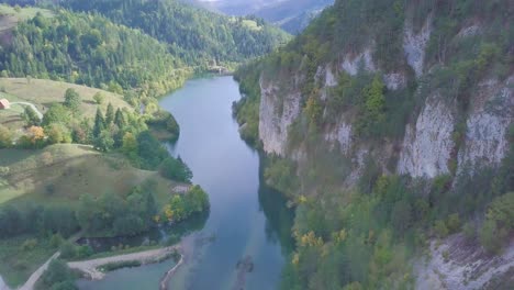 Tilting-4k-aerial-shot-of-small-lake-in-Tara-mountain,-Serbia