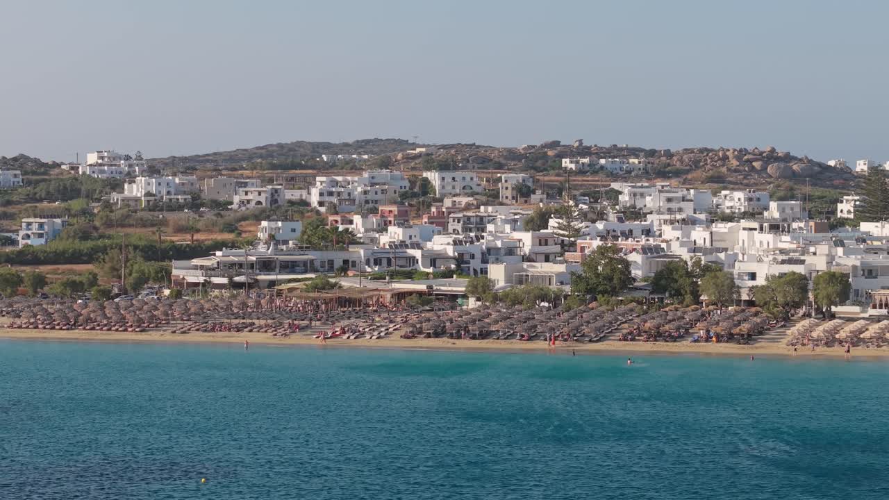 A stunning drone shot of Agios Prokopios Beach on Naxos Island captures its long golden shore, turquoise waters, and serene Aegean beauty