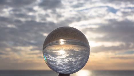 magic sunset view on the beach in a crystal ball.