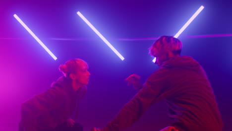 two hiphop dancers battling in nightclub stage closeup. couple dancing freestyle