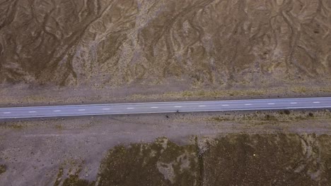 aerial pan over 2 iceland bicycists on road