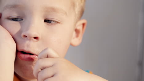 close-up shot of a little boy eating chocolate