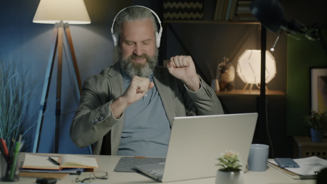 Man having a video call at night in his home office.