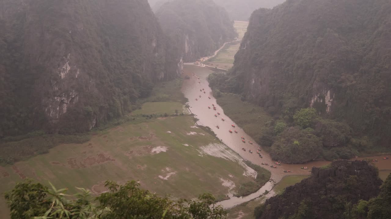 Stunning Aerial View of Boats on a River Surrounded by Foggy Mountains in Vietnam