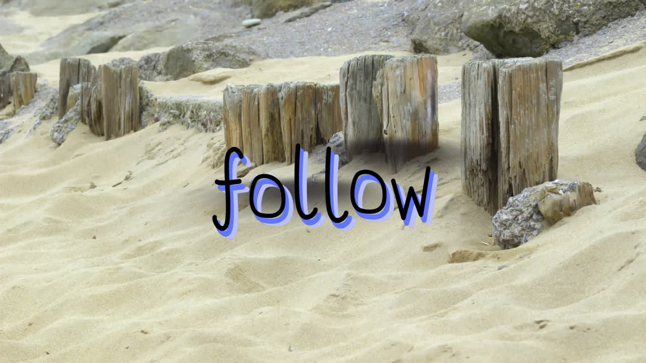 Green overlay text on weathered wooden posts on sandy beach