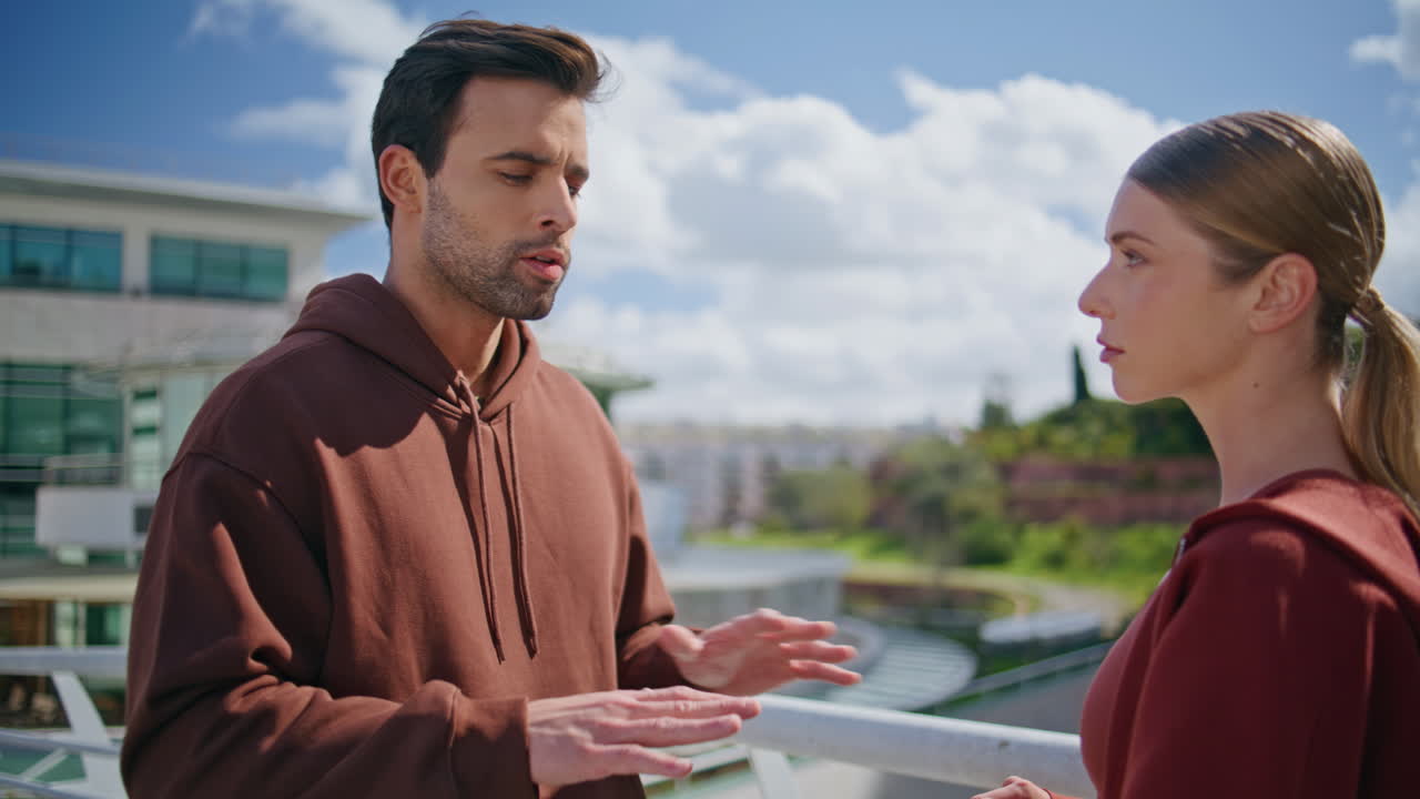 Fitness people talking street on balcony closeup. Blonde girl listening man
