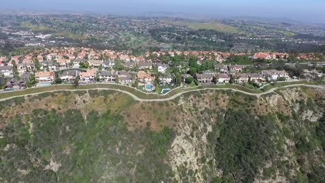 rotating aerial drone shot flying over luxury homes in laguna niguel, orange county, california that face aliso creek