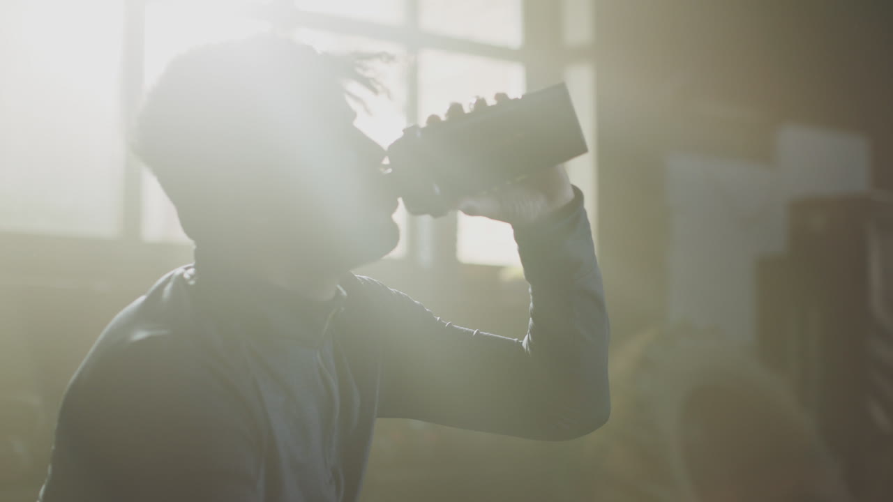 Man Drinking Sports Drink in Gym