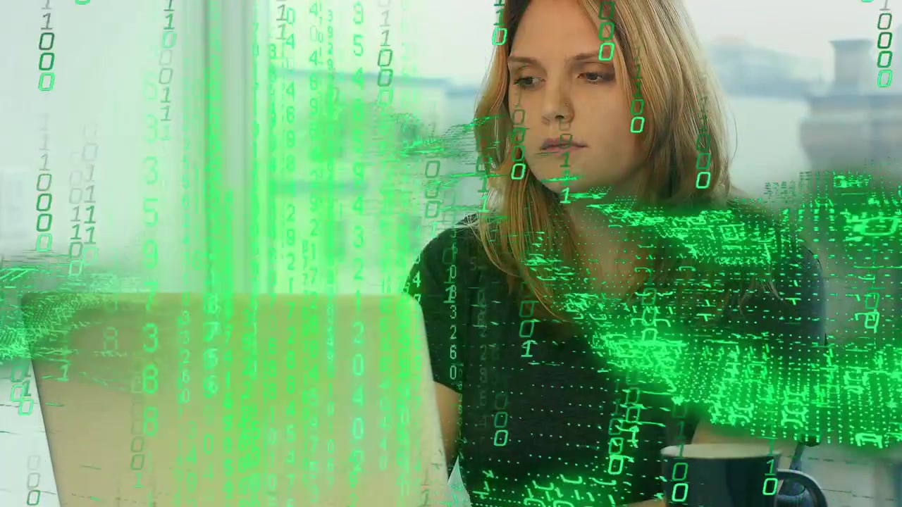 Woman typing on laptop, causing green binary overlay spreading over screen and face, analyzing data