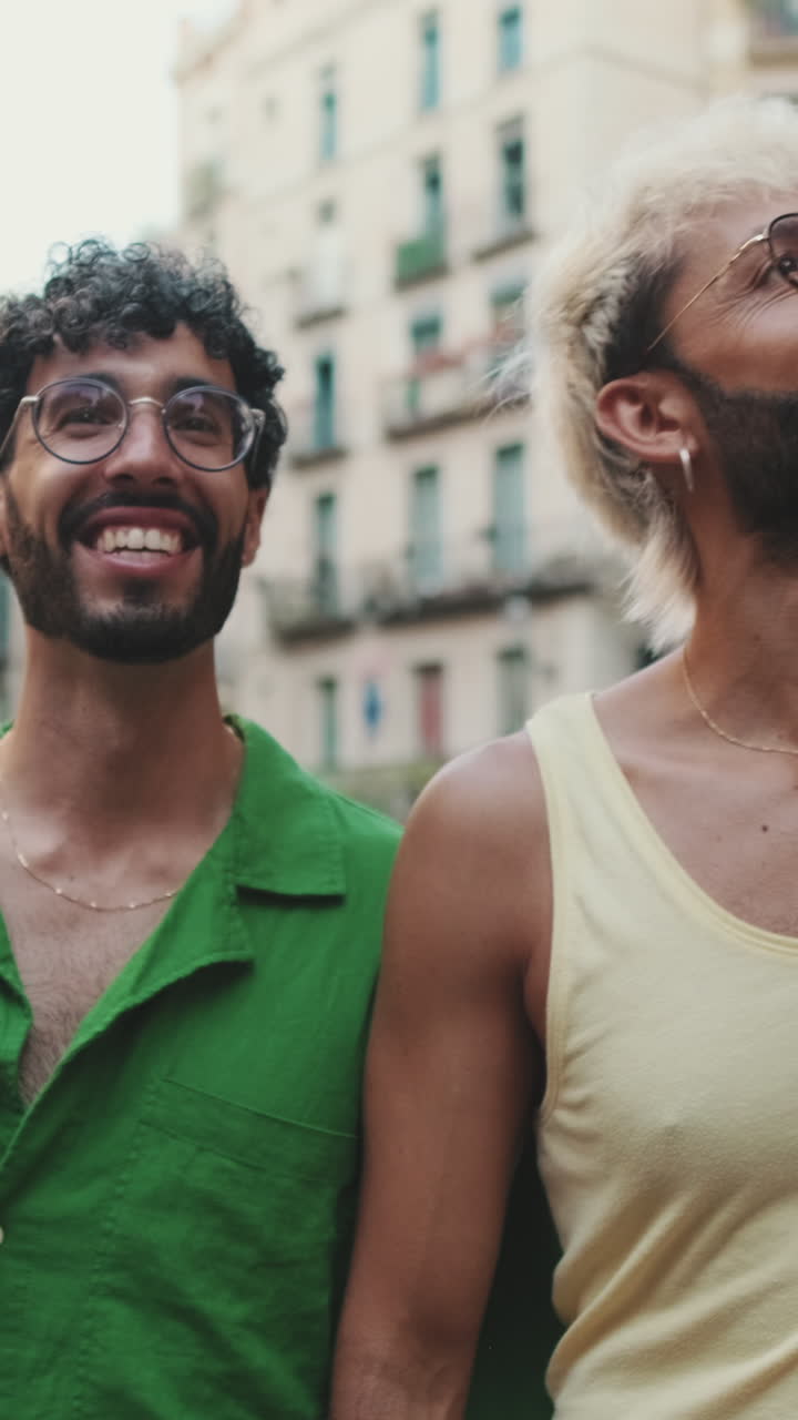 Two Happy Young Men Walking and Smiling on a City Street