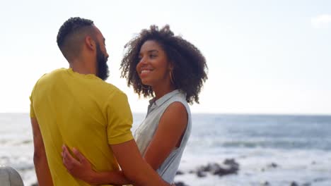 Couple-interacting-with-each-other-at-beach-4k