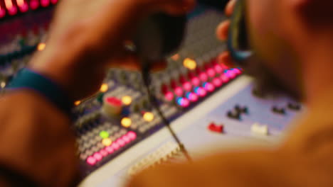 african american tracking engineer processing and mixing sounds in control room