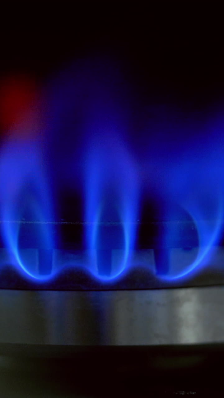 Burning blue gas stove. Detail of burning gas stove with blue flames