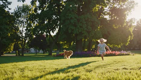 child and dog running in park