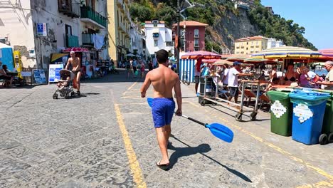 man walking through busy marina in sorrento