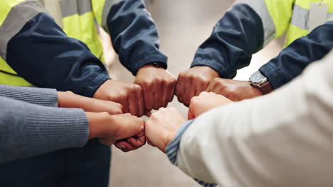 team of workers showing unity with fist bump