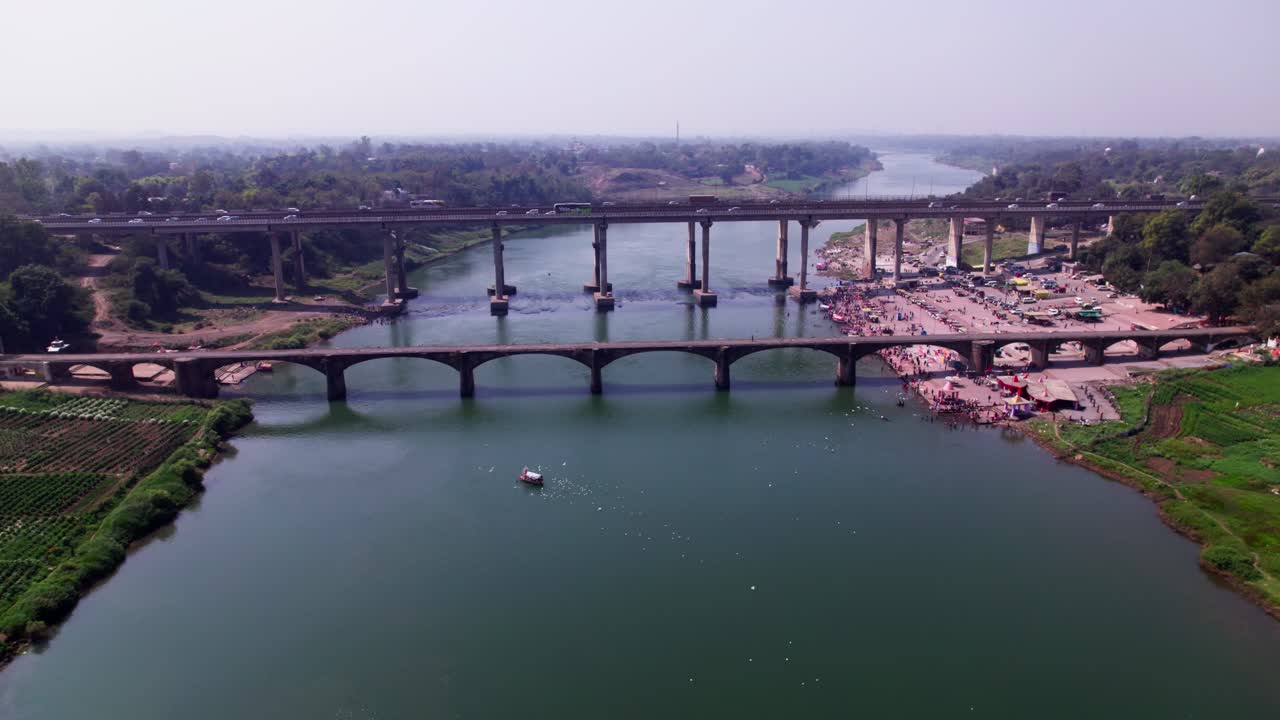 agriculture land with Tilwara Narmada River Bridge and flying birds at Jotpur, Jabalpur, Madhya Pradesh, india. day time, push back, drone shot, 4k.