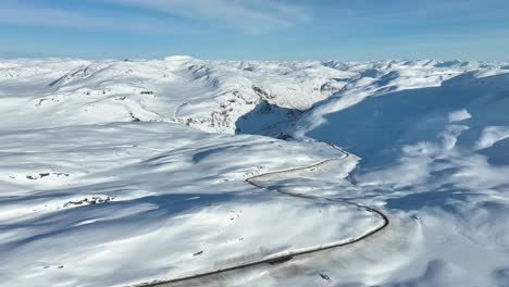 the edge of mountain vikafjell and the start of myrkdalen leading to voss - road rv 13 going down holesvingane curvy road from mountain plateu - aerial