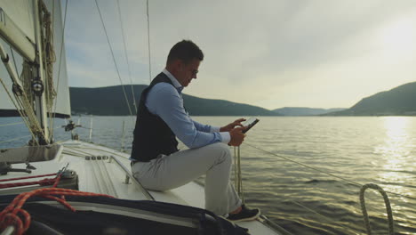 businessman working on tablet on a yacht