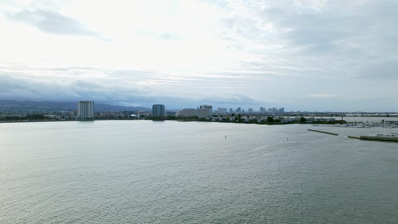 A drone captures the lively atmosphere of Emeryville Marina, zooming in on the pier and shoreline.
