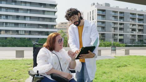 Doctor consulting with a patient in a wheelchair
