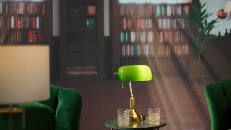 timeless refined library at social club with green chairs and whiskey glasses