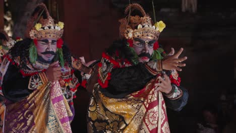 legong and ramayana traditional theater dance performance held at ubud palace, bali - king rahwana dancing with group of dancers - portrait show in slow motion