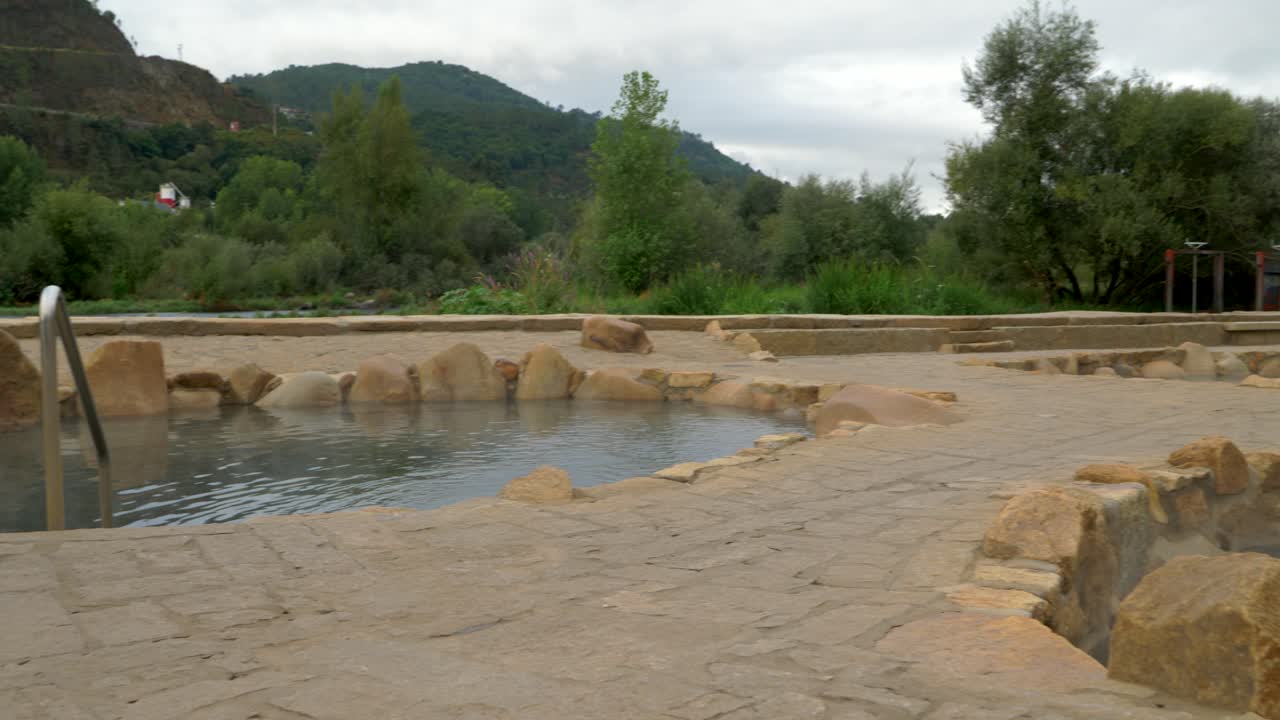 Establishing shot of Muiño da Veiga thermal baths in Ourense, Galicia, Spain