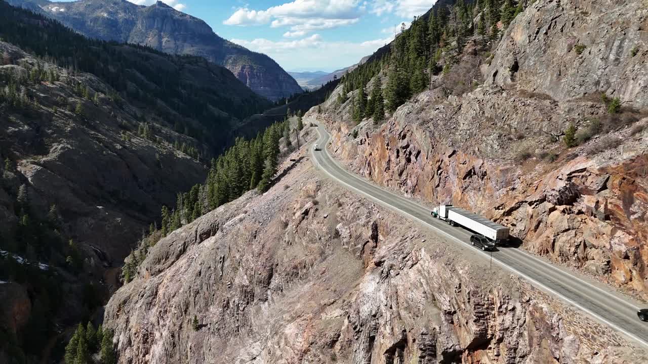 Semi Truck Driving down the highway, edge of the mountain, Colorado's Million Dollar Highway