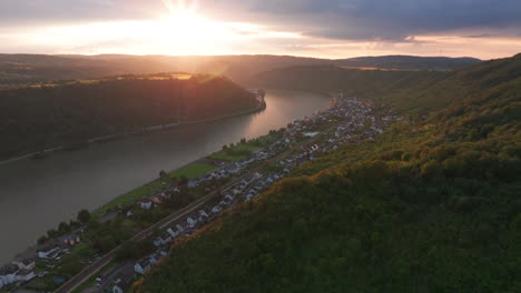 Flying-over-the-hills-of-Braubach,-Germany-with-the-sunsetting-over-the-Rhine-river