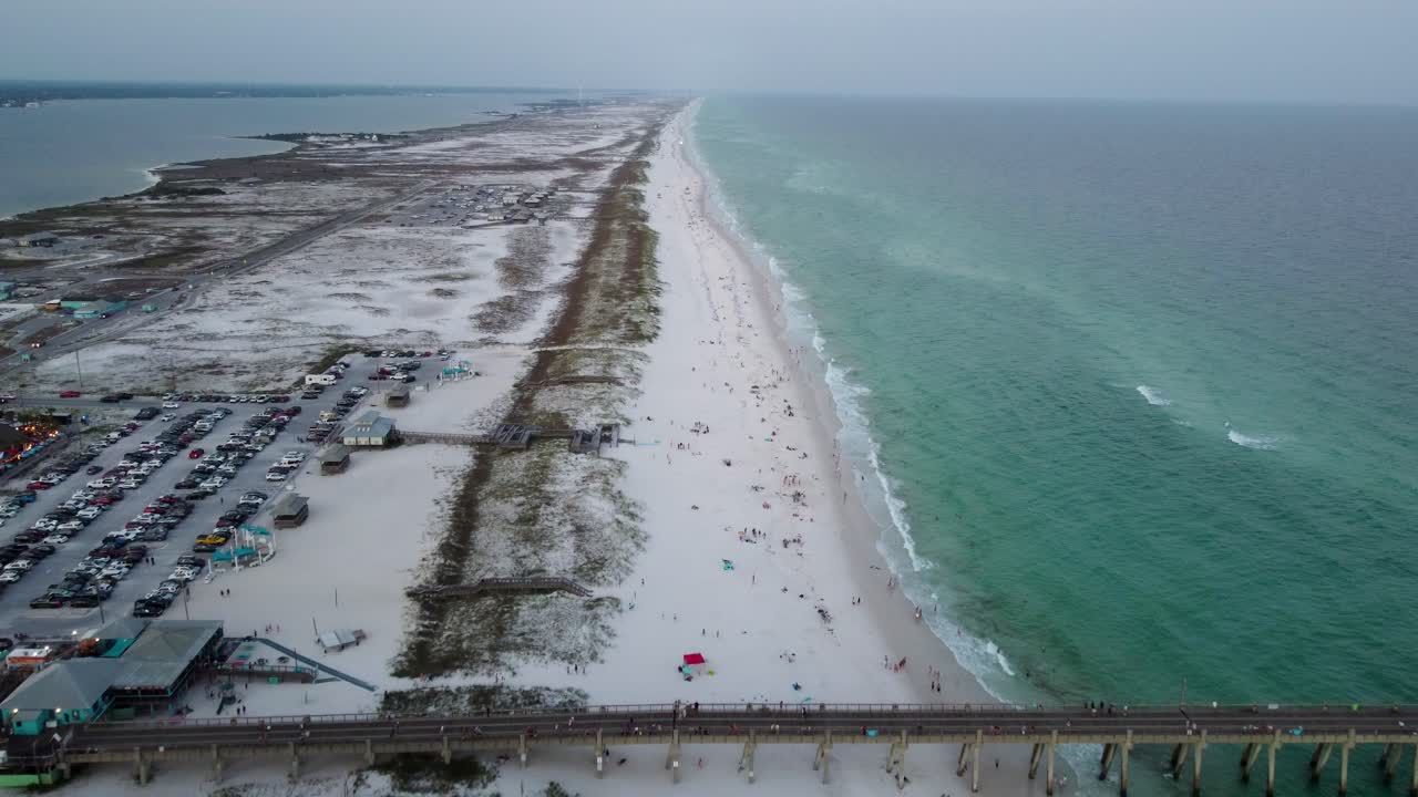 Aerial View of Crowded Beach with Pier and Turquoise Water