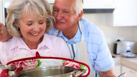 senior couple smelling a large pot