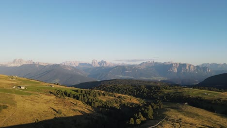 aerial drone shot of the alps while sunset with huts and farmland, beautiful nature