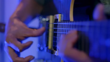 close up shot of musician's hand playing electric guitar