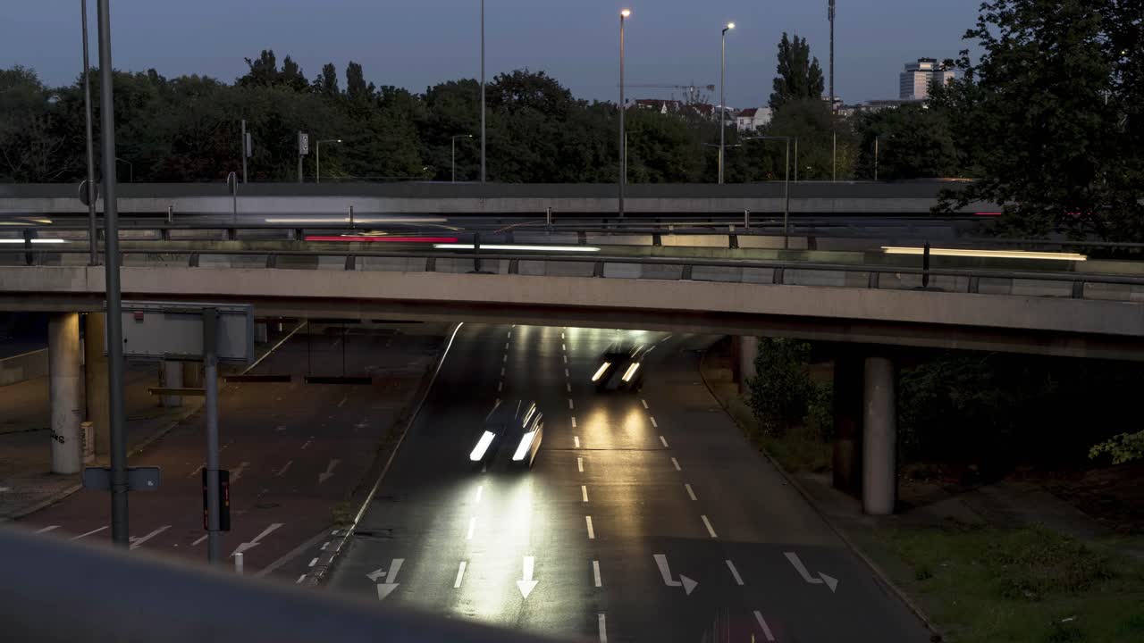 Timelapse of Cars on highway in Germany at night, headlights coming at camera, bridge across road with cars passing by