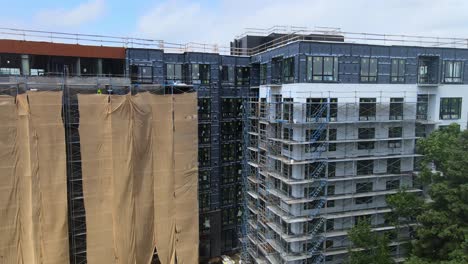 big comercial building construction zone in usa, scafle construction workers aerial view