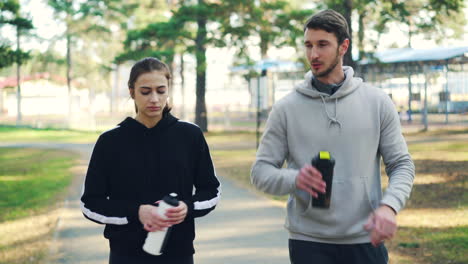 couple walking and talking in a park