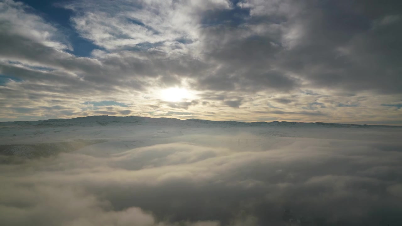Aerial View of Sun Shining Over Thick Morning Fog