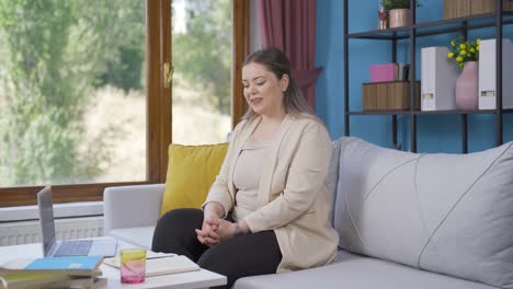 Happy-and-peaceful-young-woman.-She-is-sitting-in-front-of-the-window.