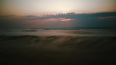 drone shot over low clouds and fog in the mountains of virginia