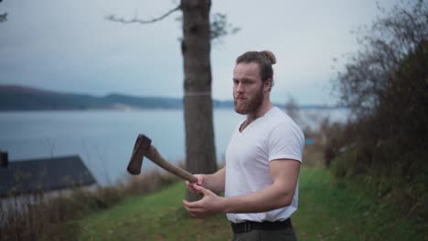 man playing with axe, throwing up and catching